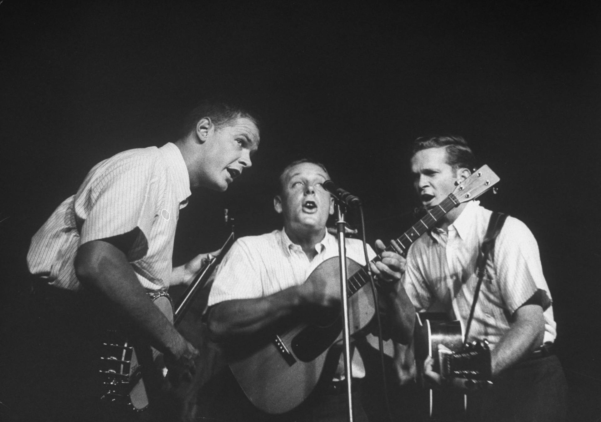 Caption: The Kingston Trio Performing On Stage in the 1970s Wallpaper