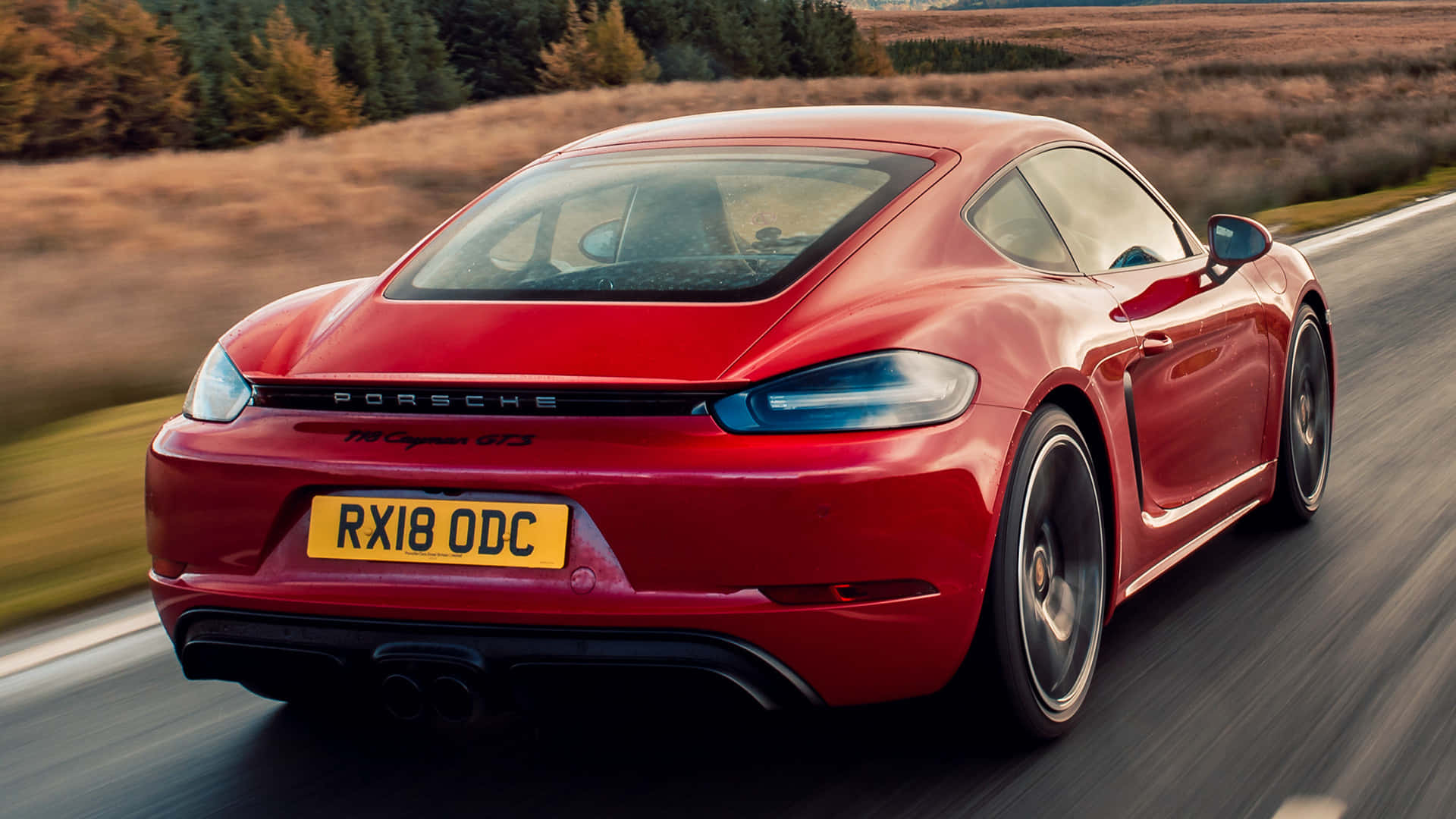 The Luxurious Porsche 718 Cayman In Striking Red Color Wallpaper