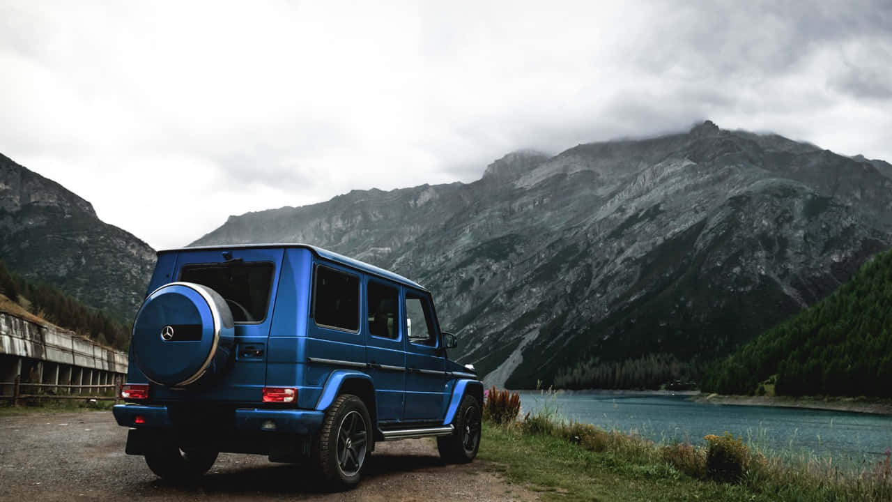 The Majestic Mercedes Benz G-class Illuminated Against The Night Sky Wallpaper