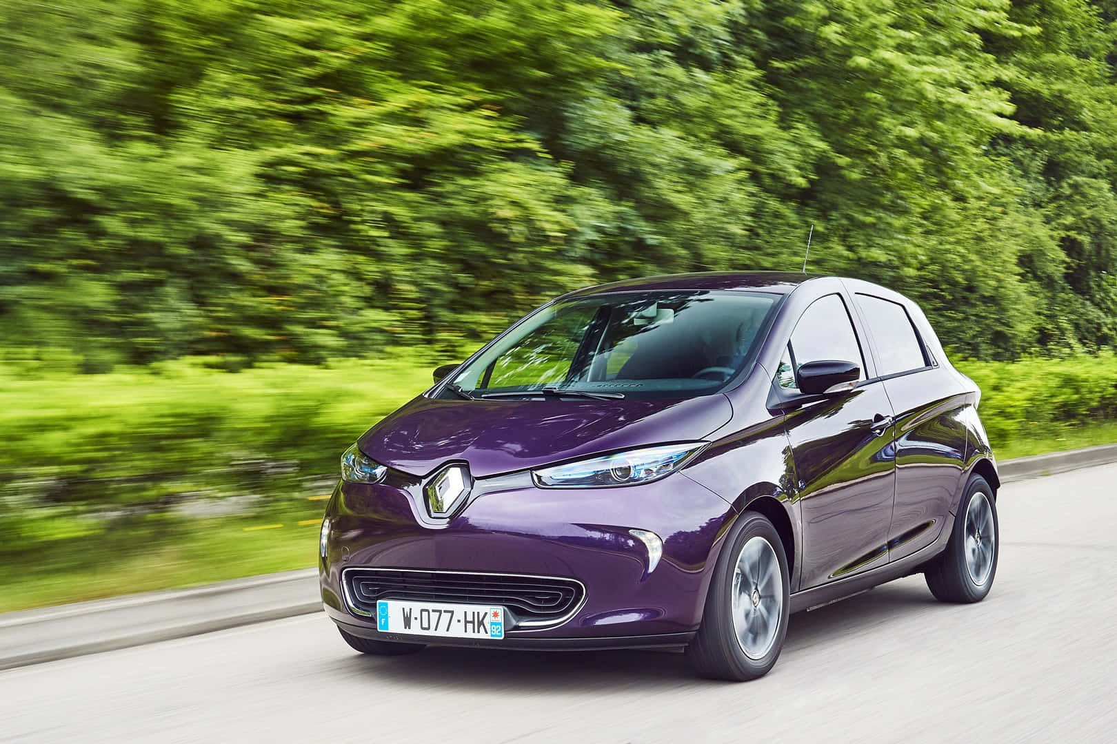 The New Eco-friendly Renault Zoe Electric Car On A Serene Highway Wallpaper