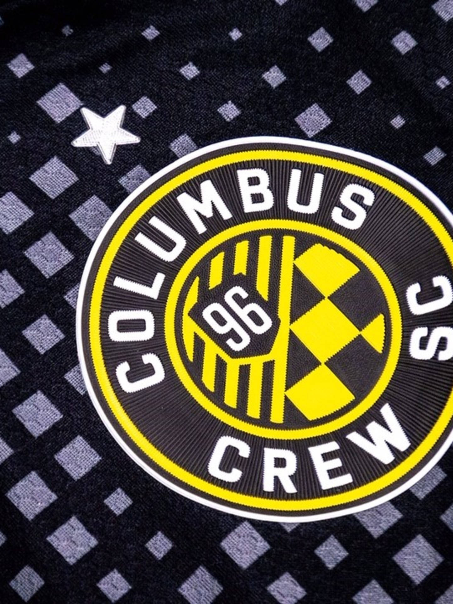 The New Logo Of Columbus Crew In A Stylish Black Background Wallpaper