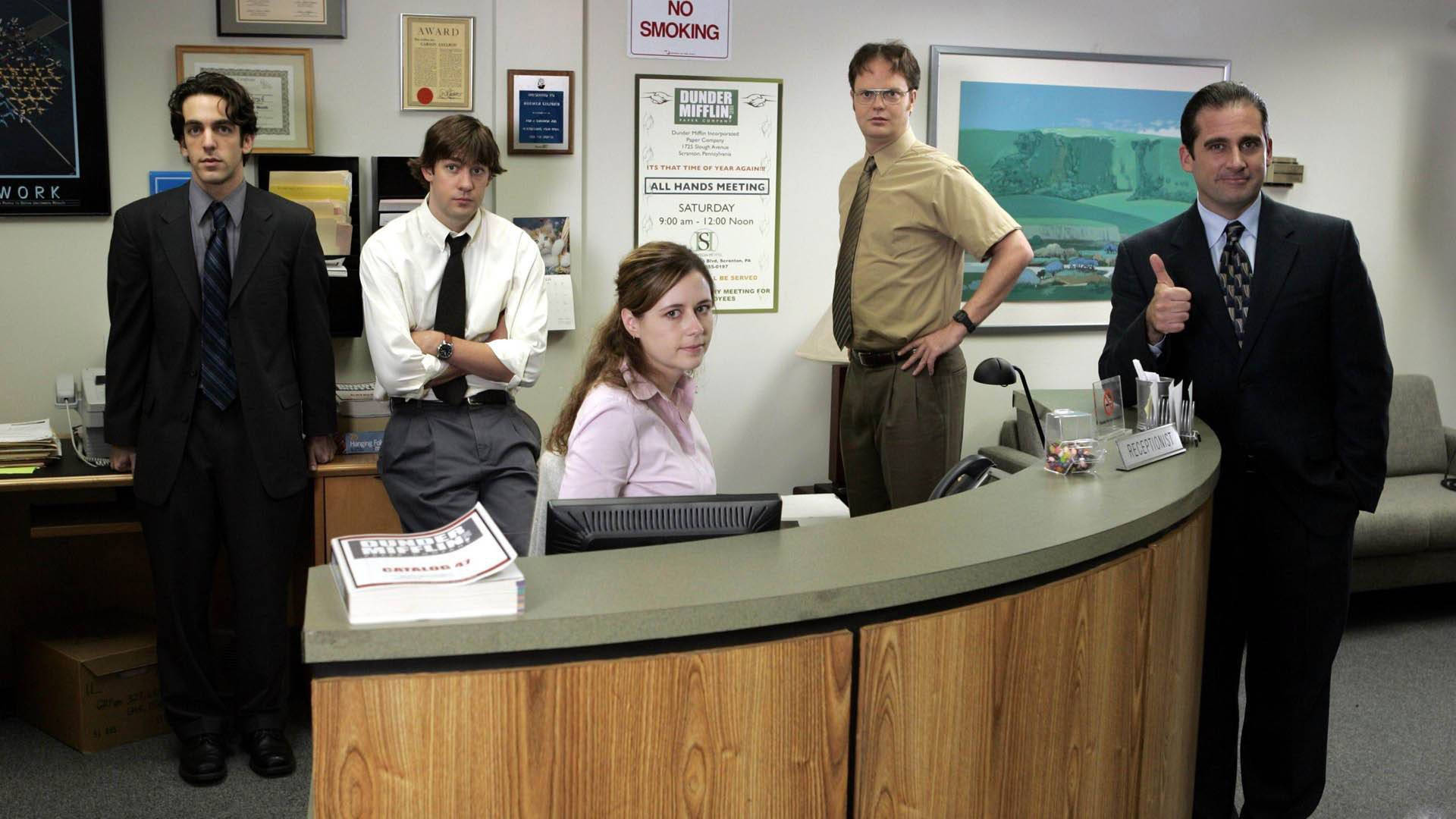 Download The Office cast at Dunder Mifflin's reception desk Wallpaper