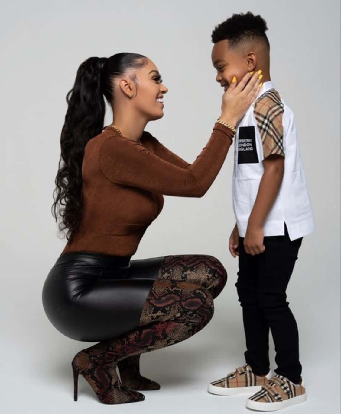 A Woman And A Child Are Posing For A Photo Wallpaper