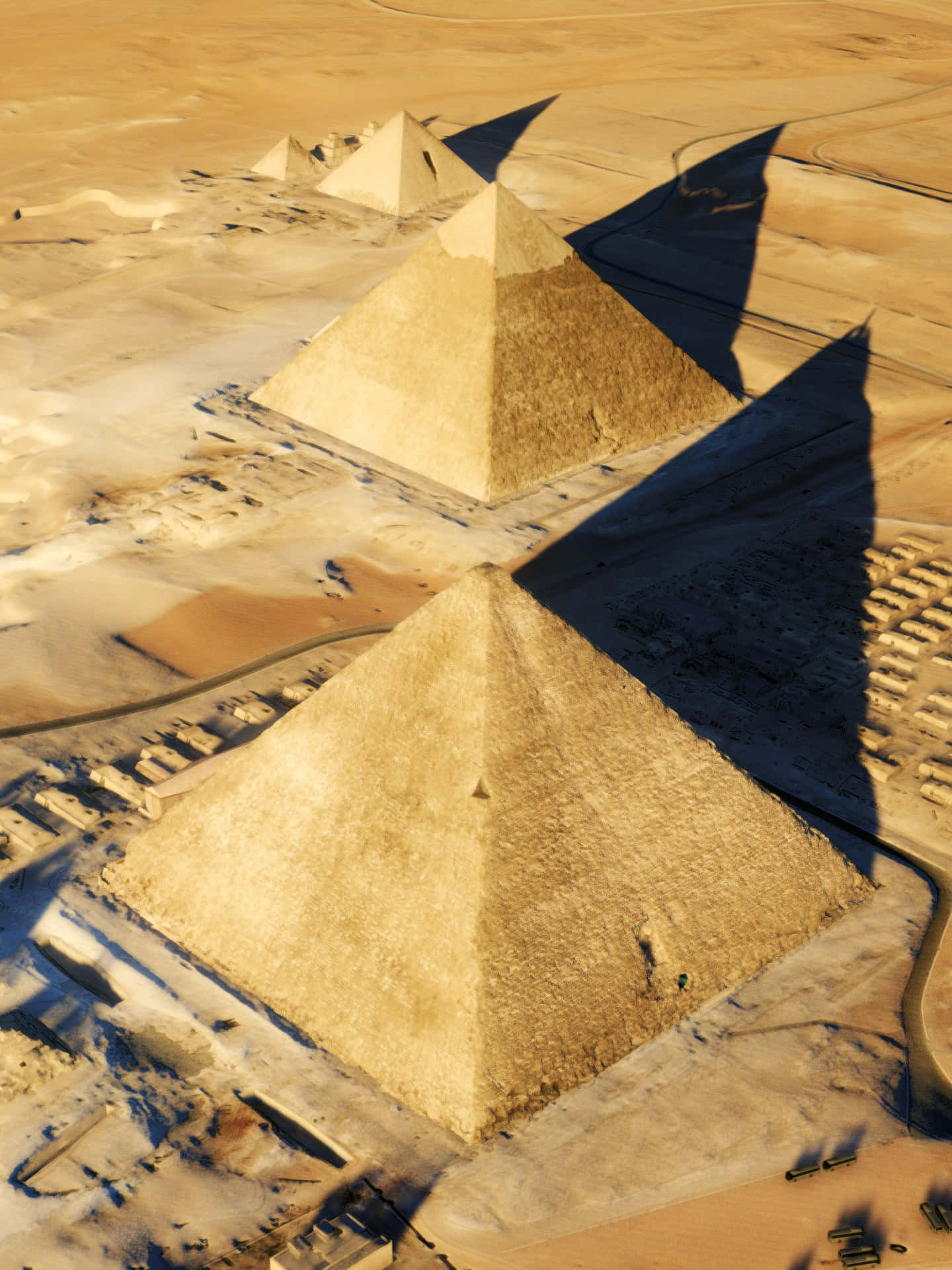Pyramiderne i Giza kaster skygge på ørkenens sand Wallpaper