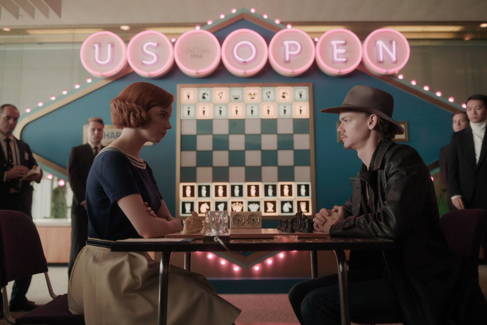 “The Queen’s Gambit: Beth Harmon takes on Benny Watts in a dramatic chess match.” Wallpaper