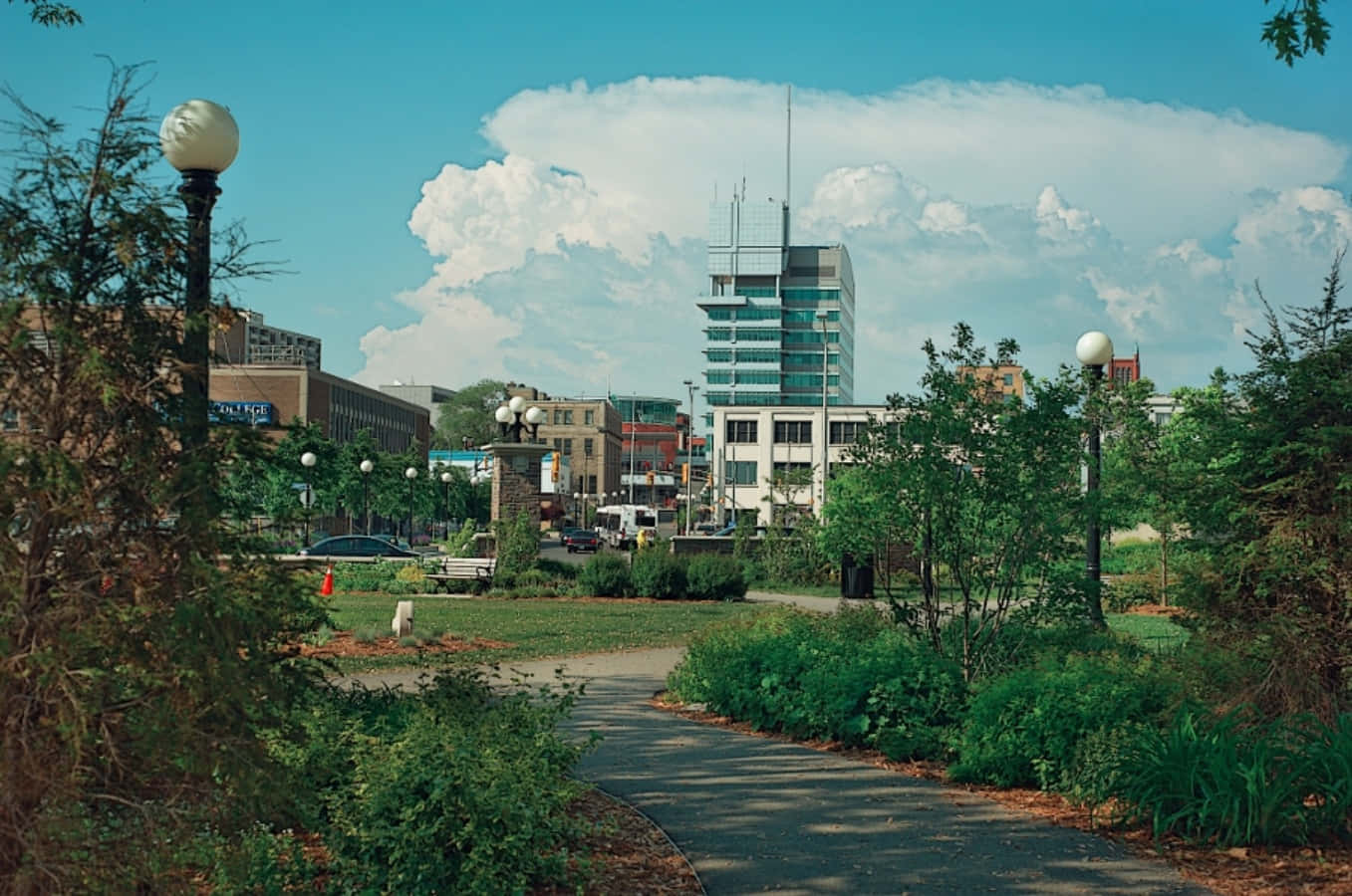 The Scenic Beauty Of Kitchener: A Picturesque Winding Road Amidst Breathtaking Lush Greenery Wallpaper