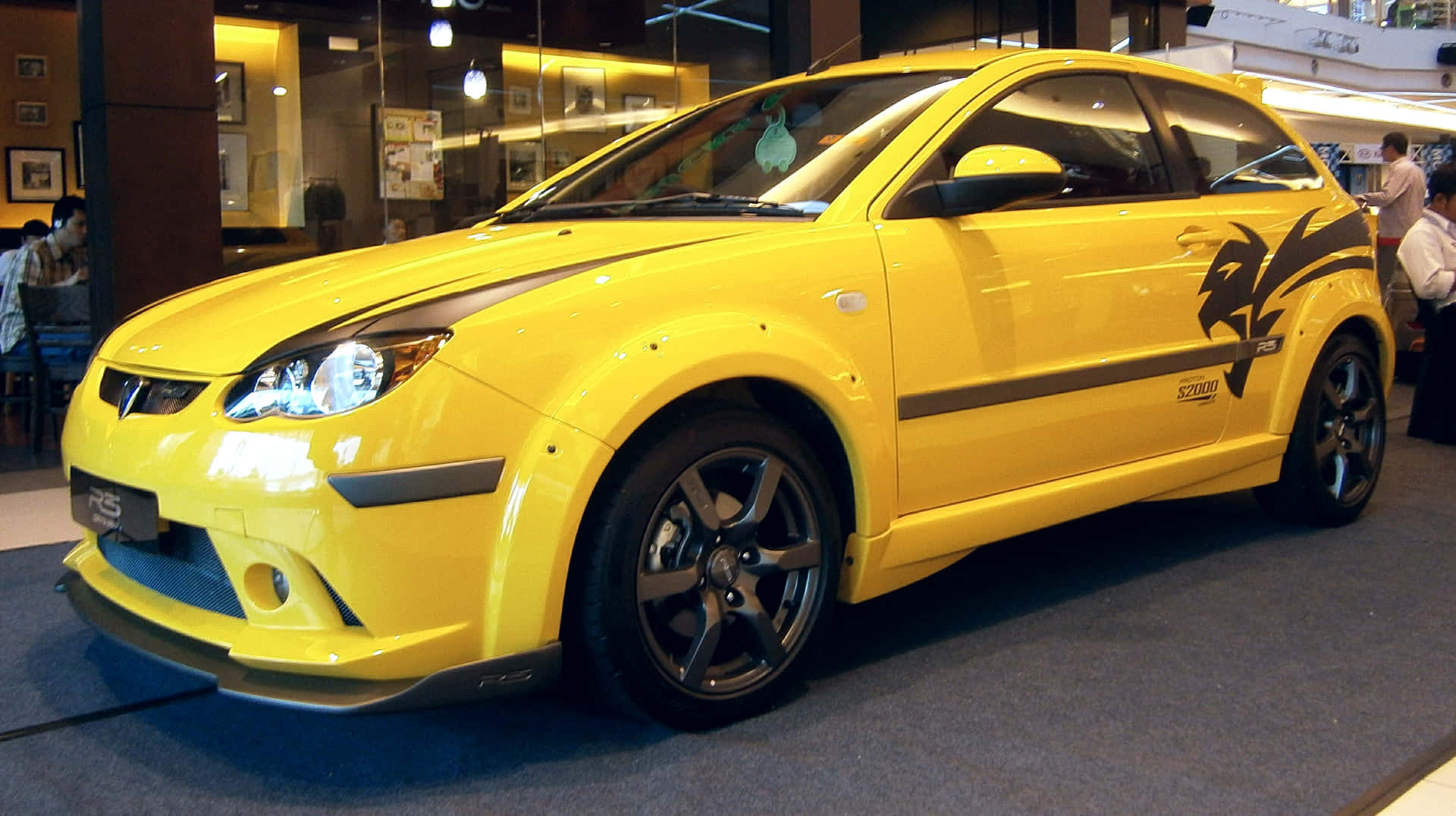 The Sleek Proton Satria-neo Shines In City Lights Wallpaper