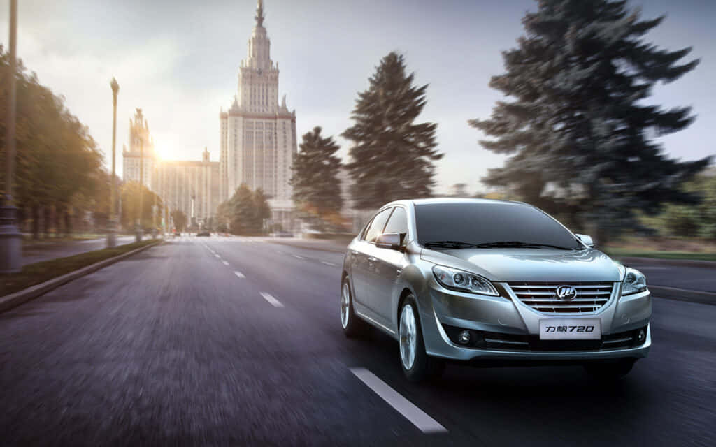 The Stylish Lifan 620 Sedan Cruising On The Highway. Wallpaper