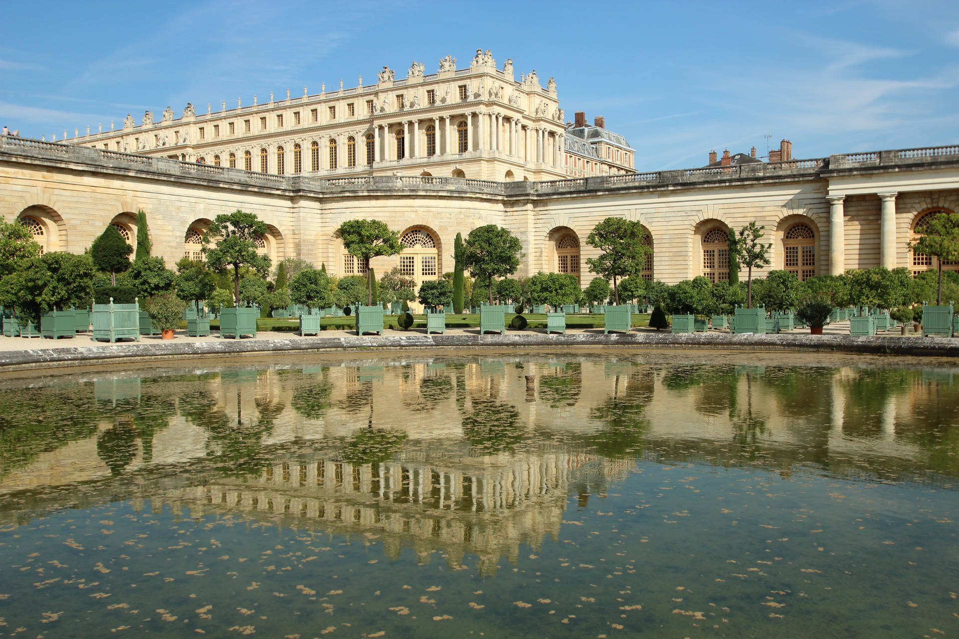 Majestic Versailles Orangerie against a Clear Blue Sky Wallpaper