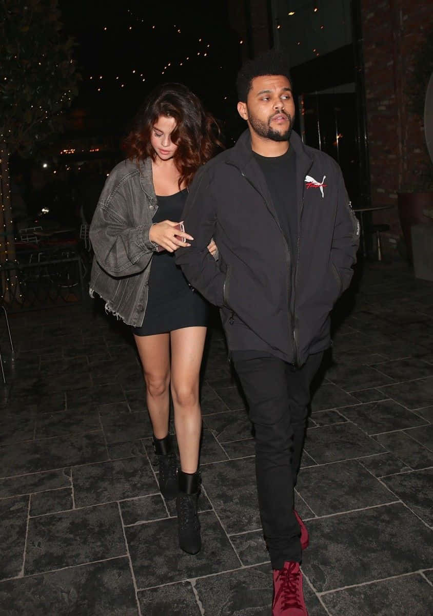 The Weeknd standing tall in a leather jacket