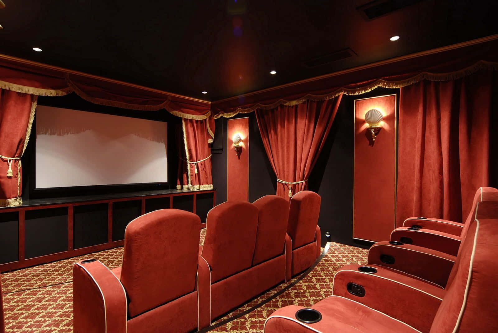 A Home Theater With Red Curtains And Red Seats