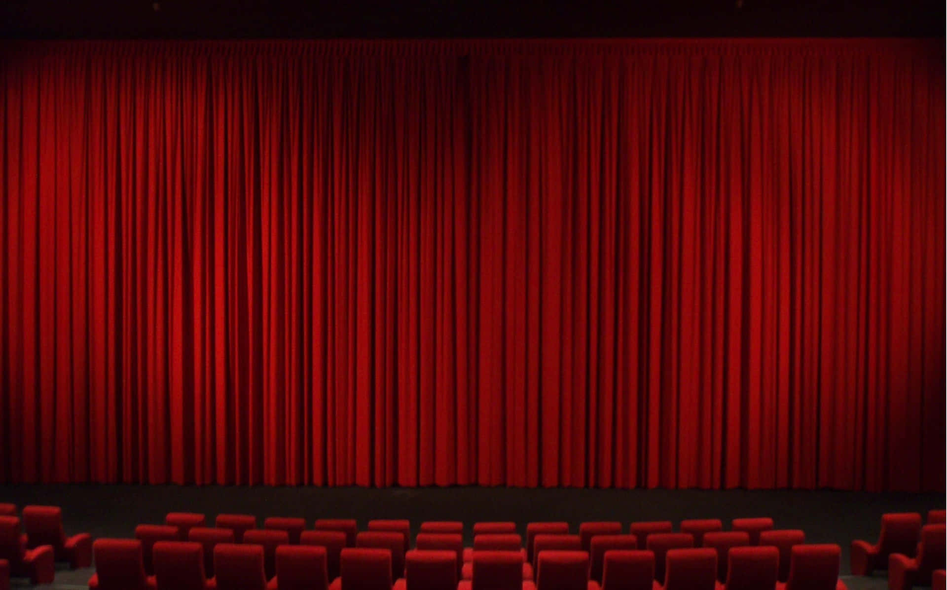 Theater With Long Red Curtains Wallpaper