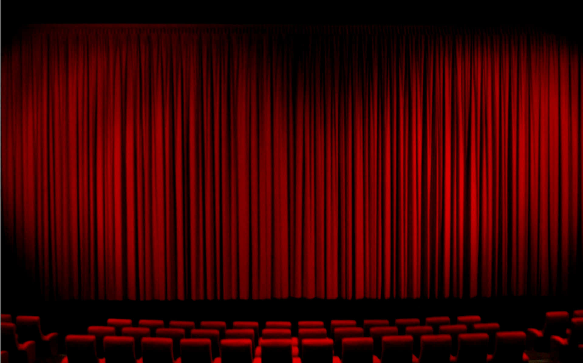 Theater With Red Curtains And Red Chairs Wallpaper