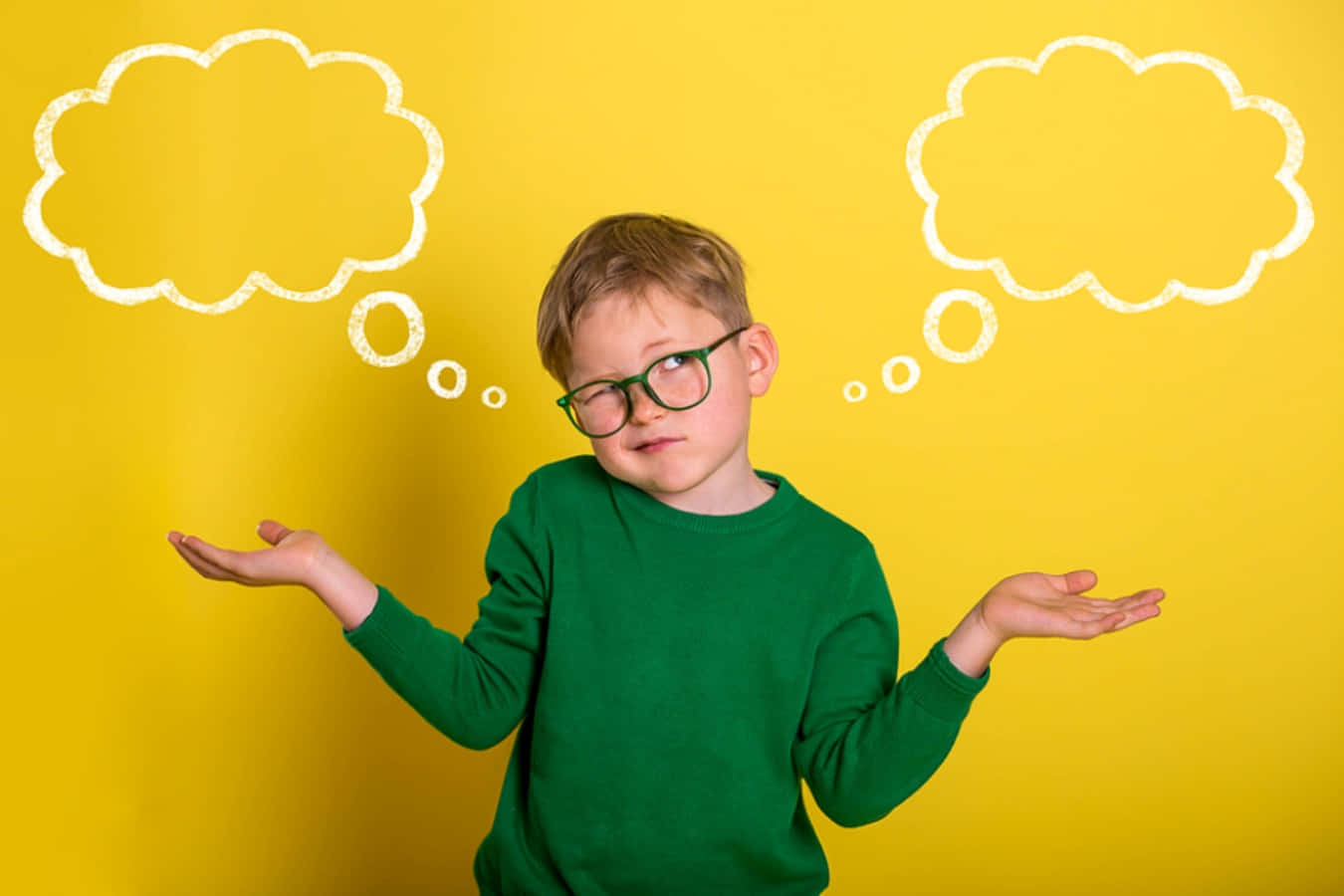 A Young Boy With Glasses And Thought Bubbles