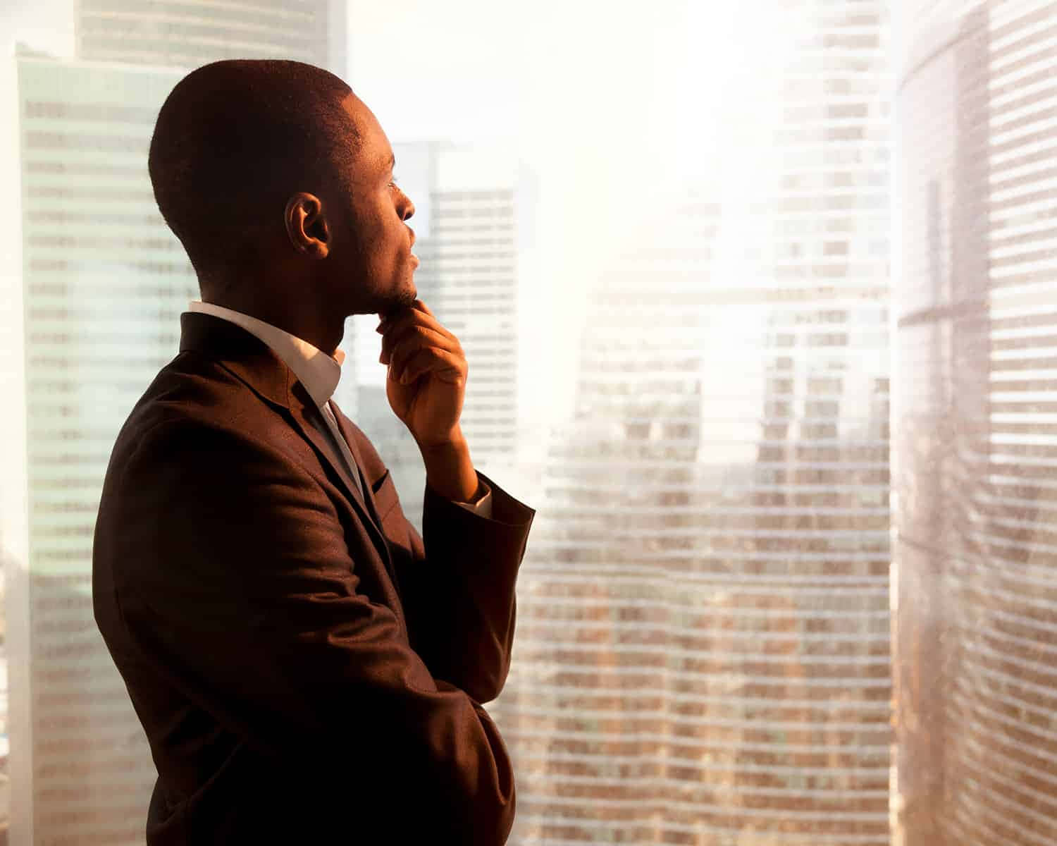 A Businessman Looking Out Of A Window