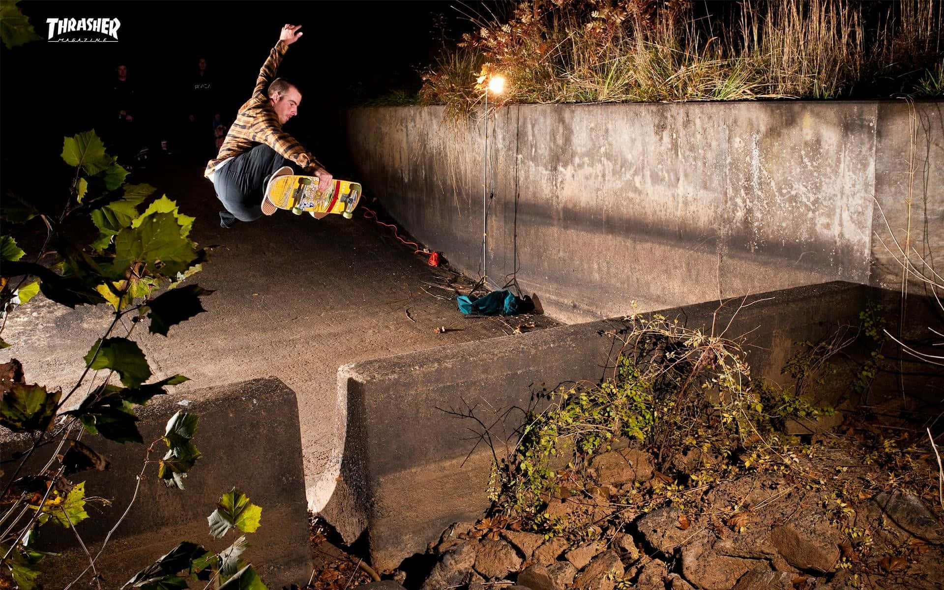 A Skateboarder Is Doing Tricks On A Concrete Wall