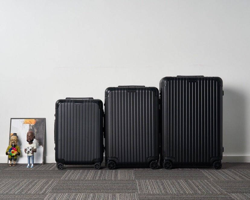 Three Black Rimowa Suitcases Wallpaper
