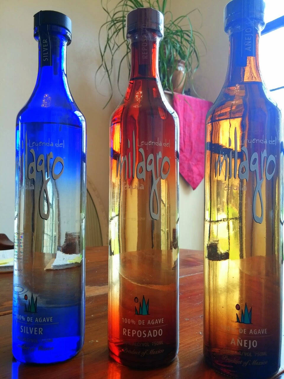 Three Milagro Tequila On Table Wallpaper