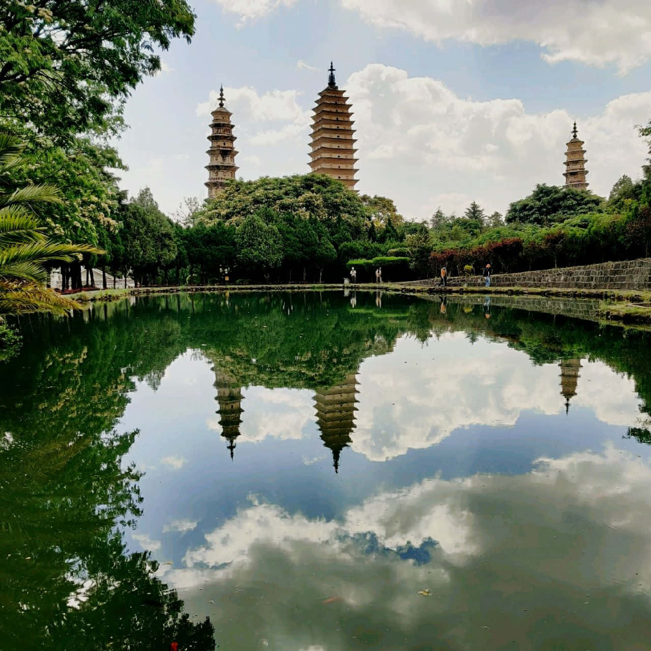 Three Pagodas Near River View Wallpaper