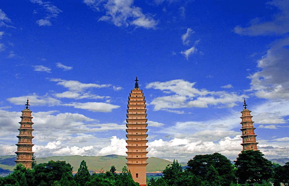 Three Pagodas Under A Rich Blue Sky Wallpaper