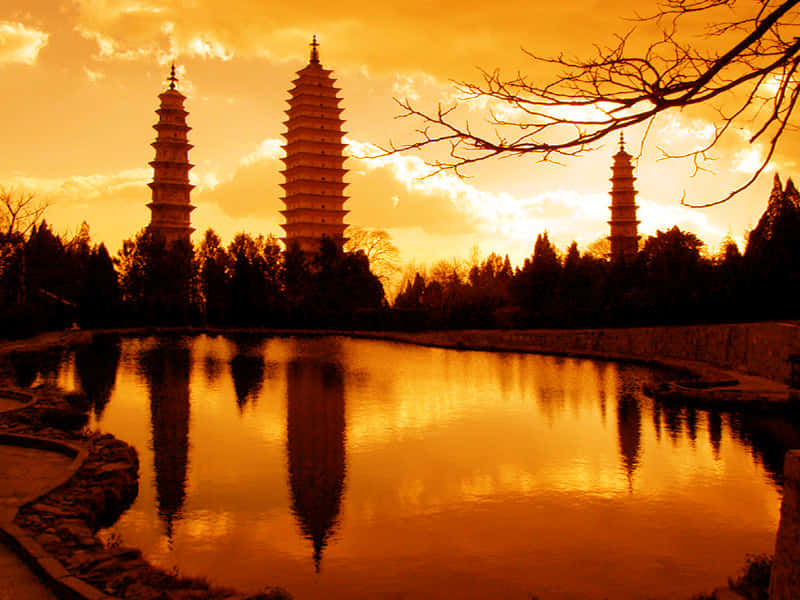 Three Pagodas Under Sunset Sky Wallpaper