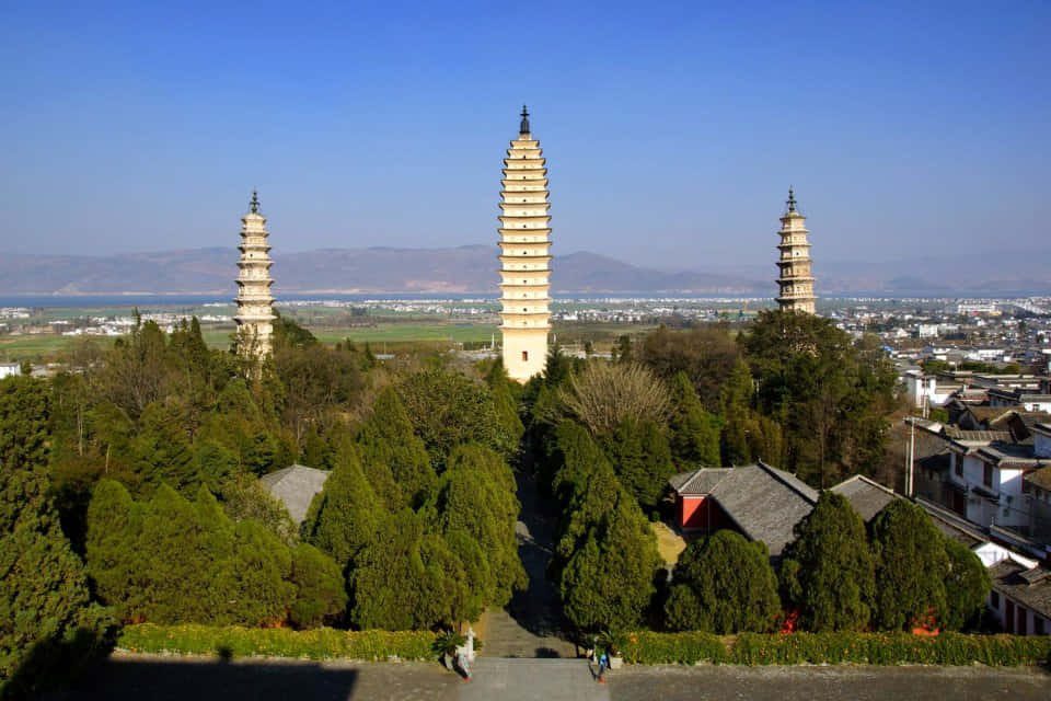 Three Pagodas With Green Trees Wallpaper