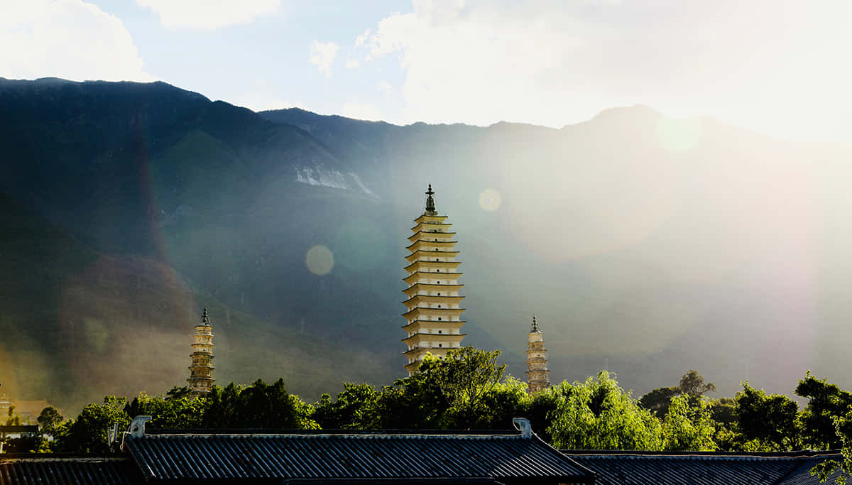 Three Pagodas With Lens Flare Wallpaper