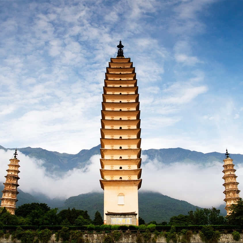 Three Pagodas With Wispy Clouds Wallpaper