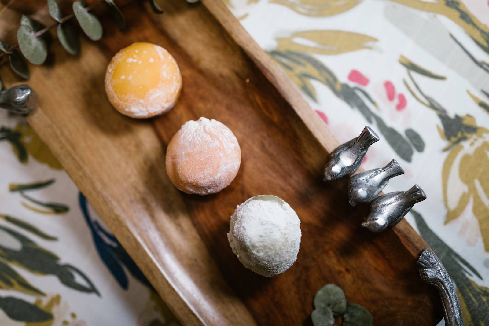 Three Pieces Of Mochi On A Wooden Tray Wallpaper