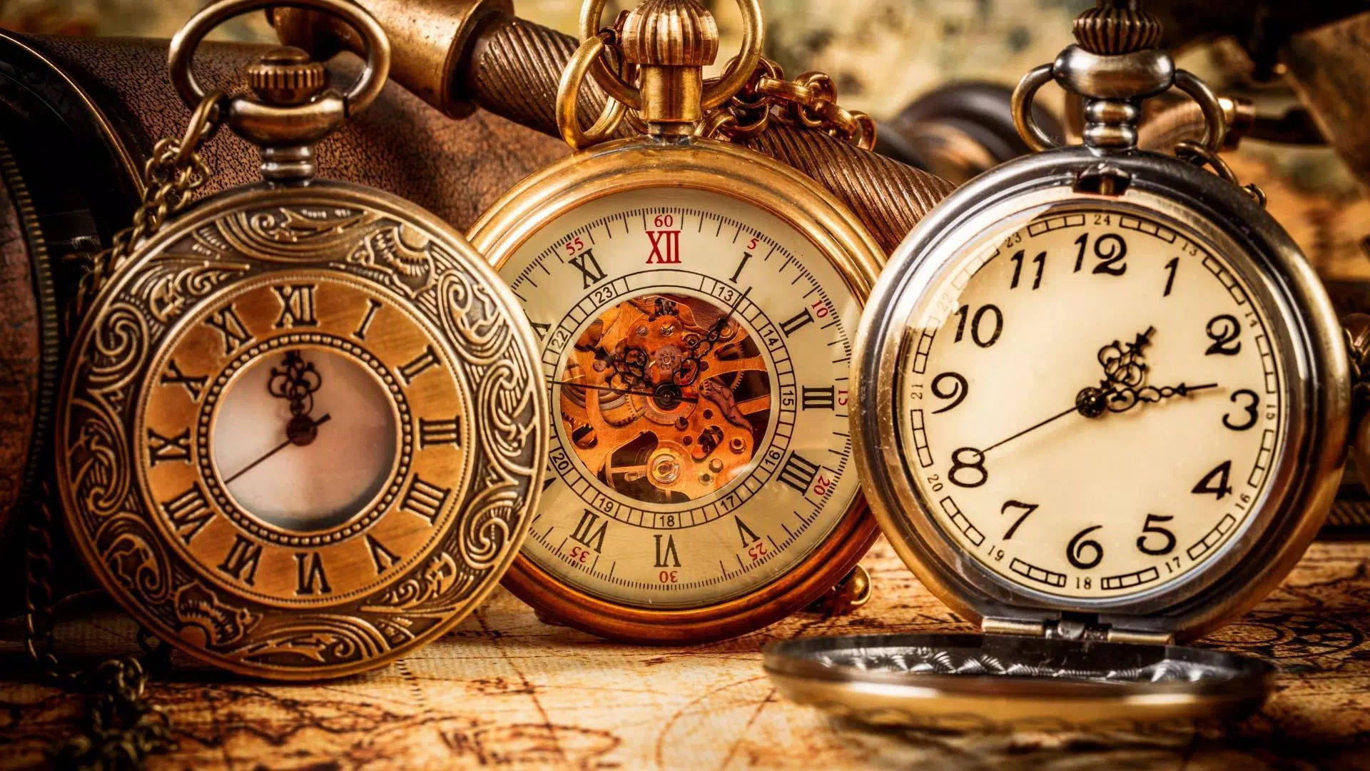 Three Pocket Watches Showing Time Wallpaper