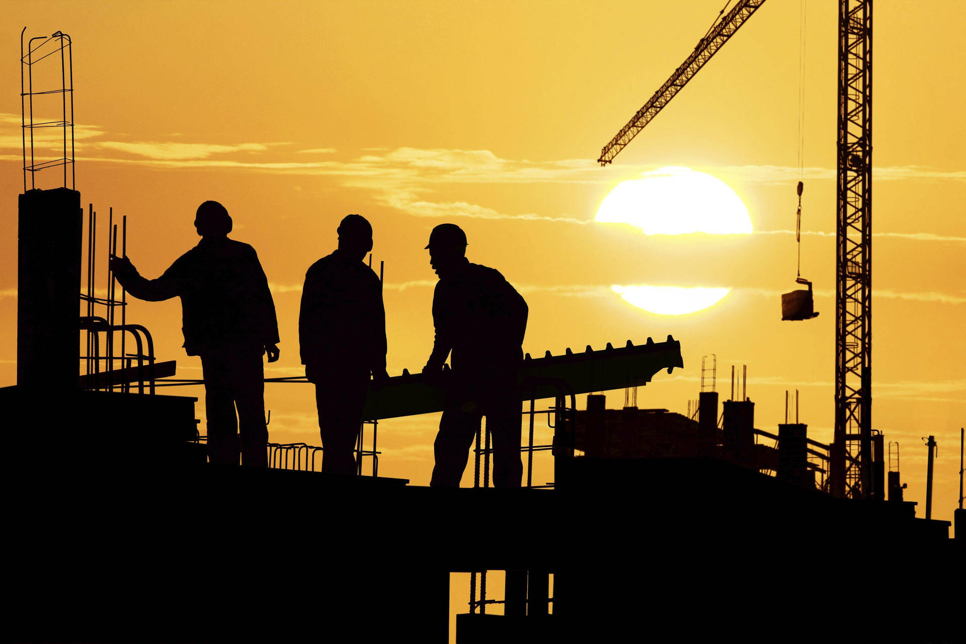 Three Silhouetted Construction Workers Wallpaper
