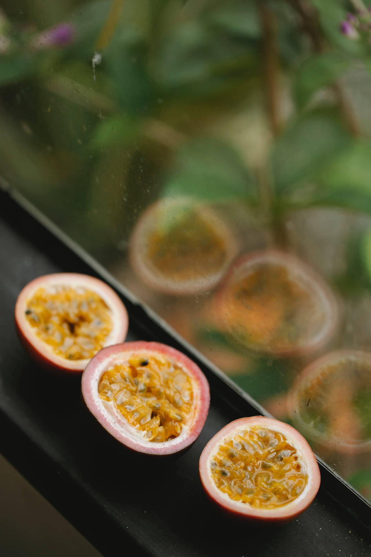 Three Sliced Passion Fruit By The Window Wallpaper