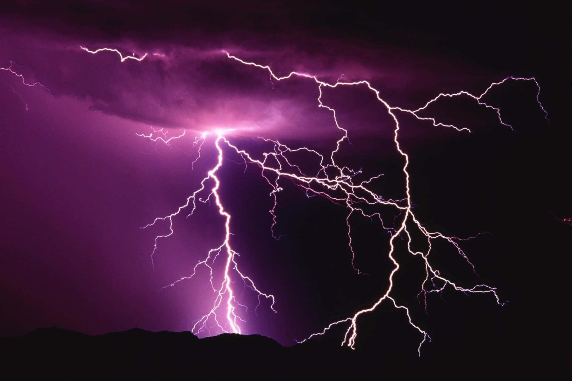 A bolt of lightning illuminates a dark storm cloud.