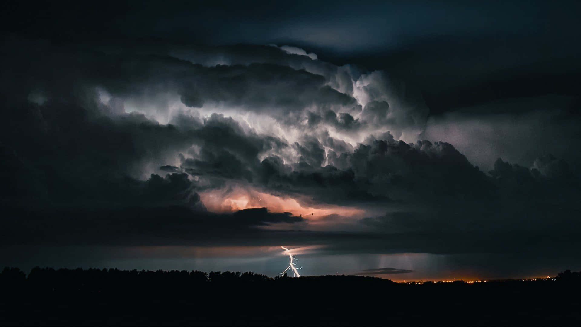 A powerful thunderstorm rushes across the sky.