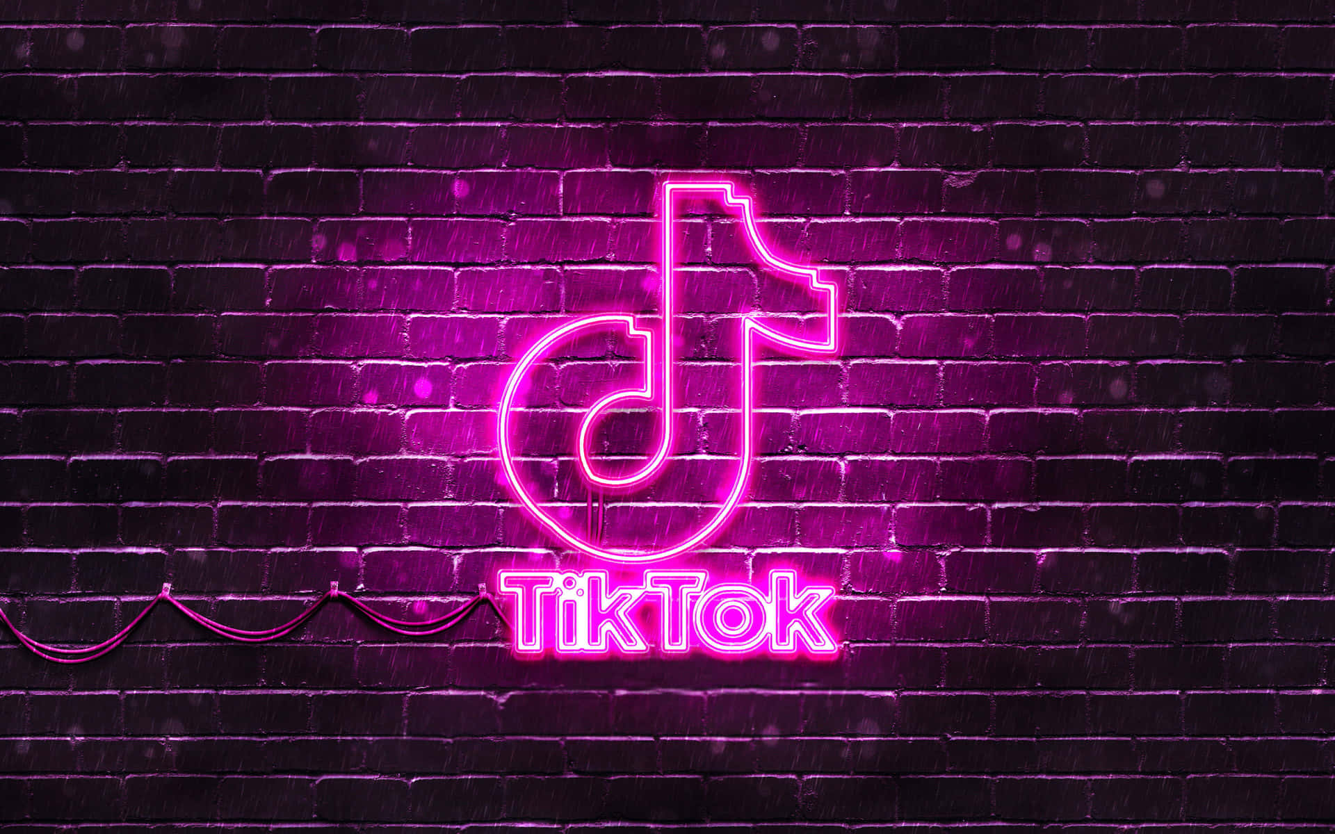 Det ikoniske logo af Tiktok på en levende pink rutet baggrund Wallpaper
