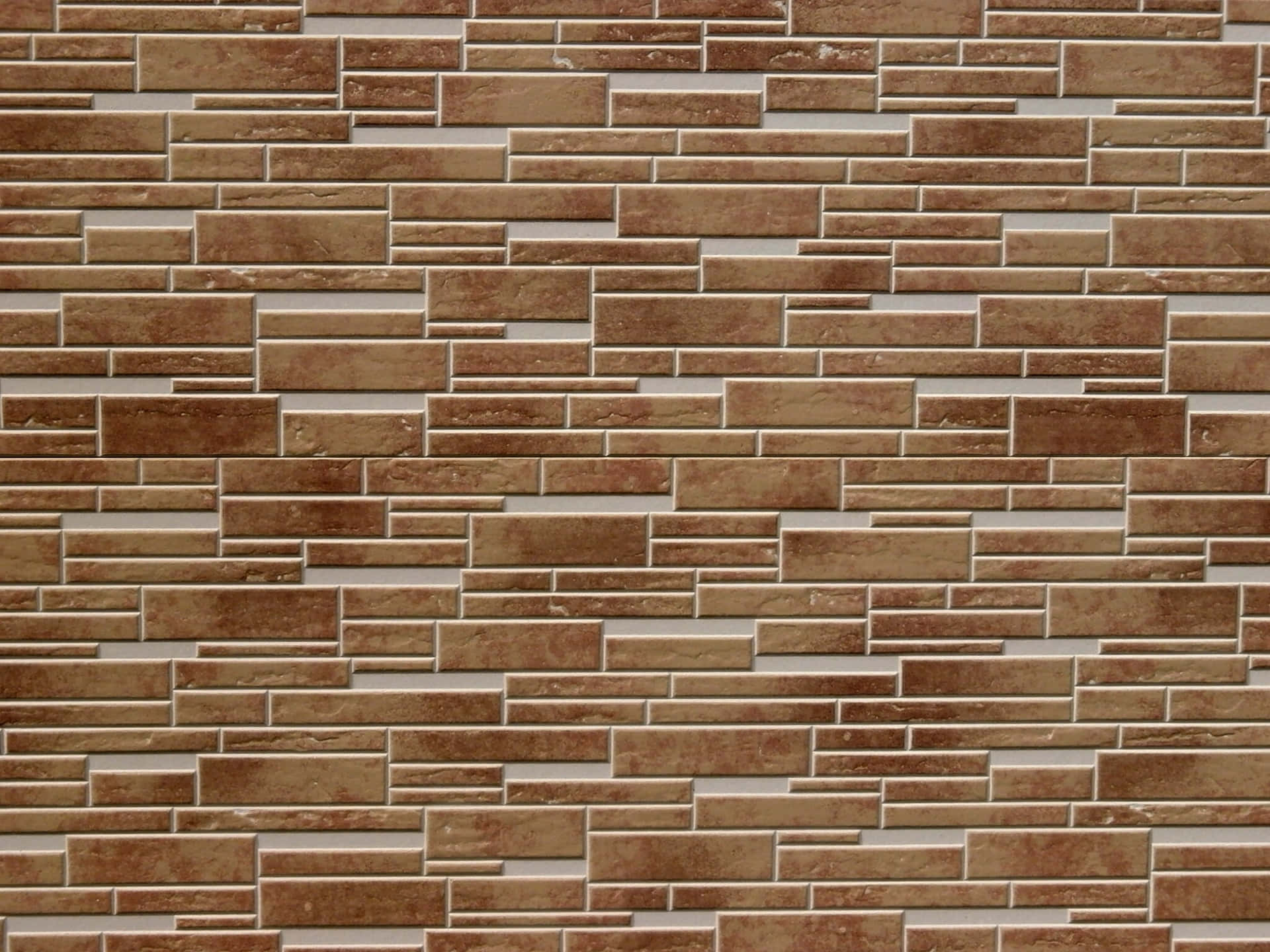 A Close Up Of A Brick Wall With Brown And White Bricks