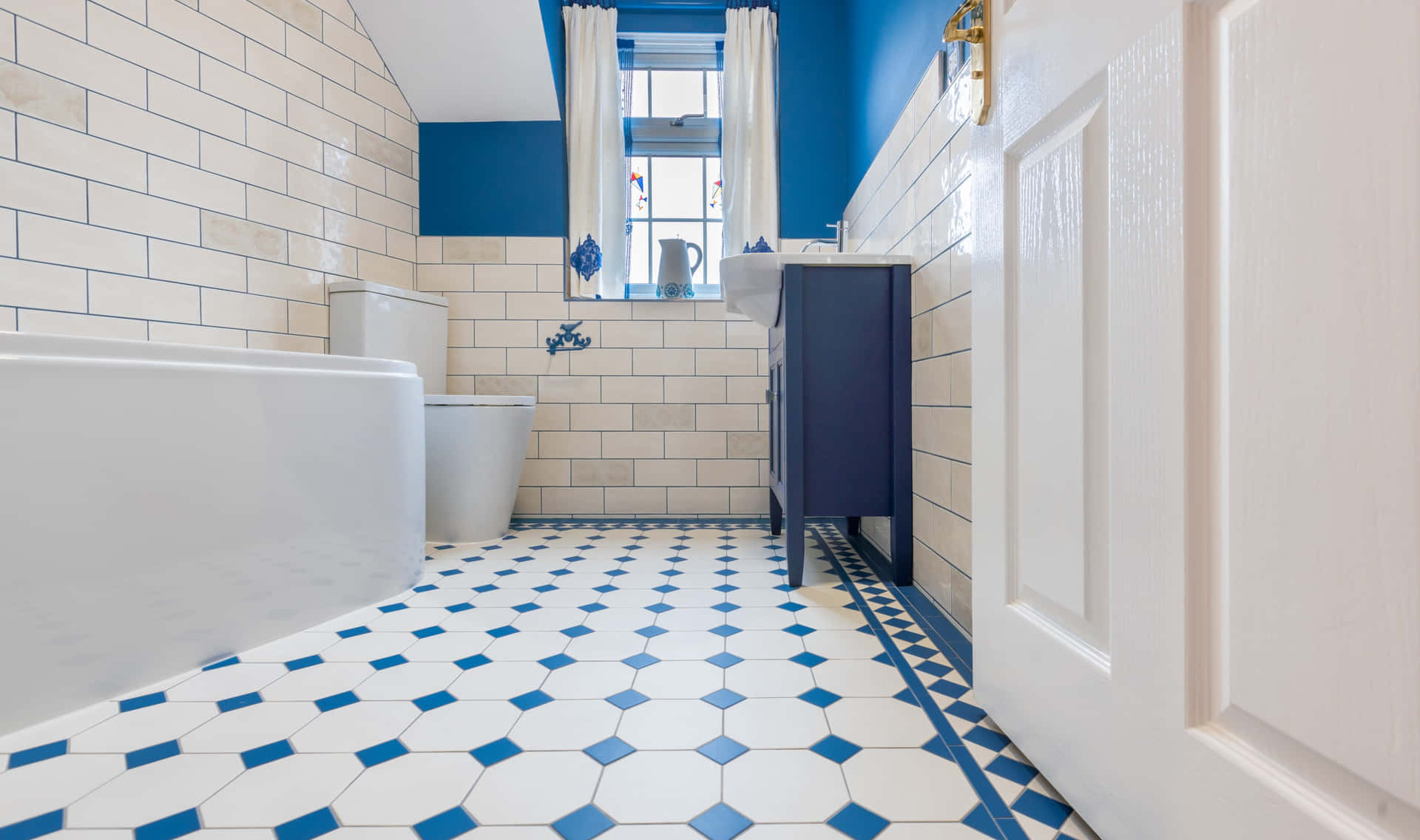 A Bathroom With Blue Walls And White Tile