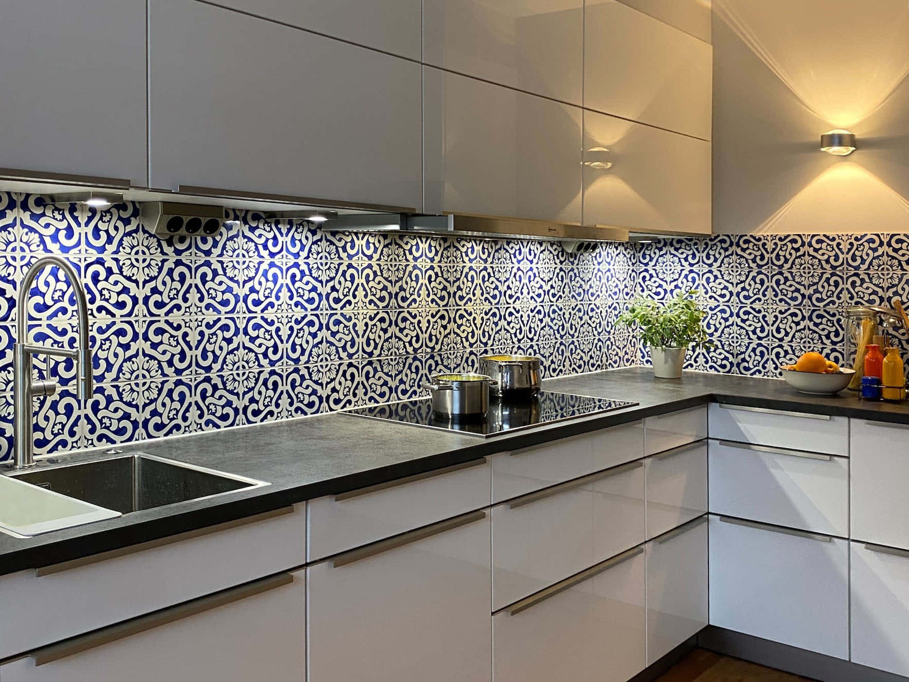 A White Kitchen With Blue And White Tile