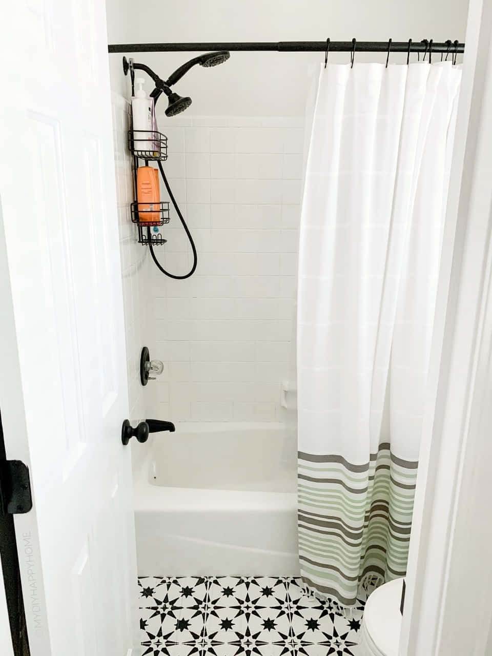 A Bathroom With Black And White Tiled Floors