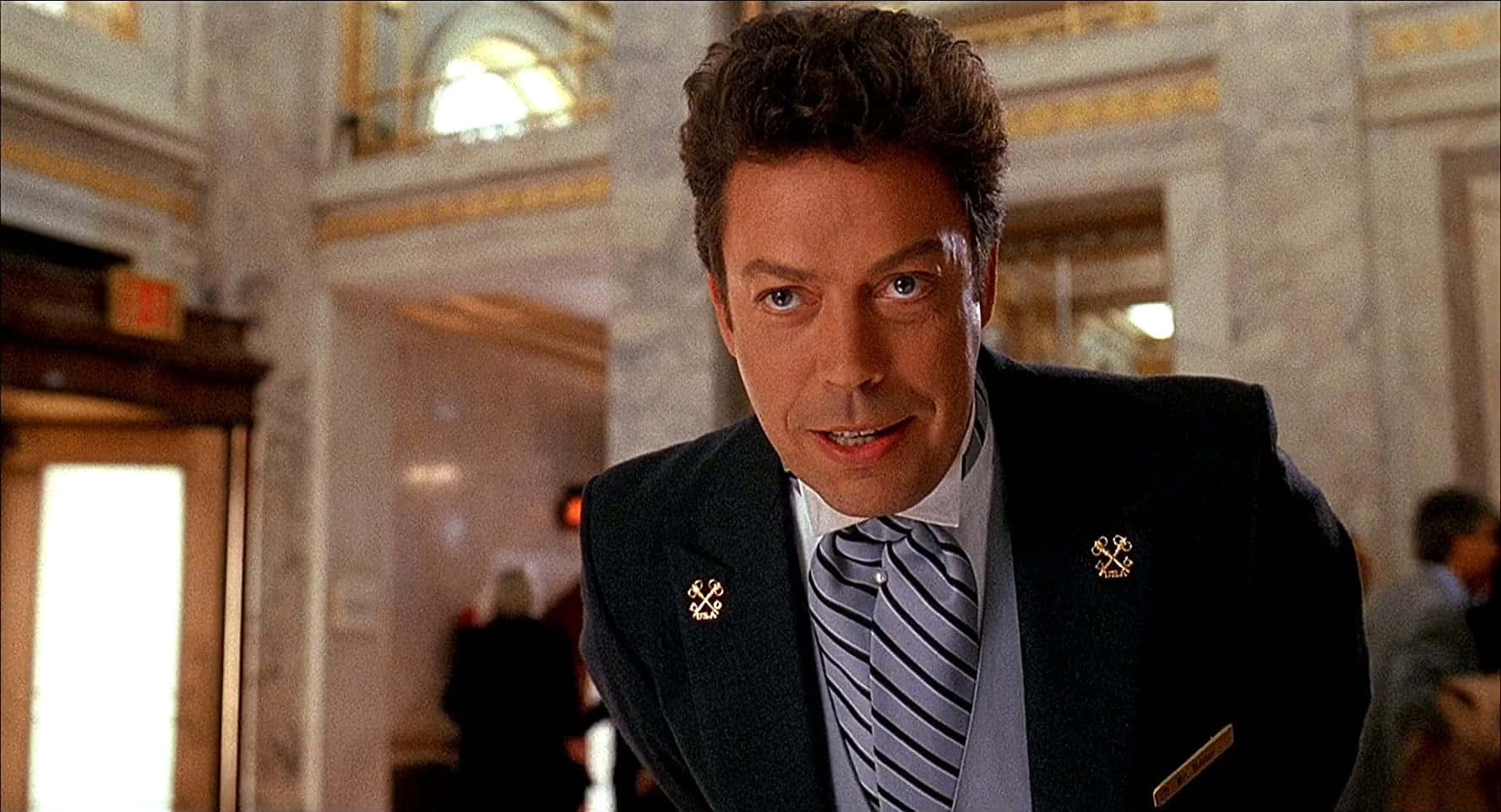 Legendary Actor Tim Curry Smiling in an Iconic Pose Wallpaper