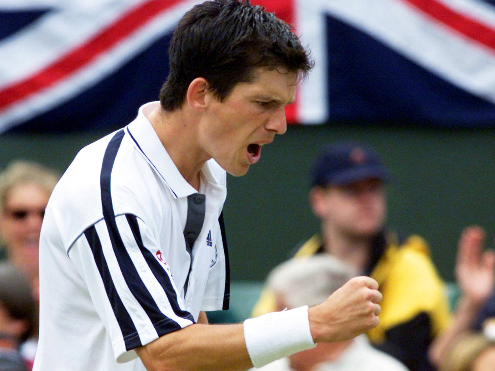 British Tennis Icon Tim Henman Celebrating Victory with Clenched Fist. Wallpaper
