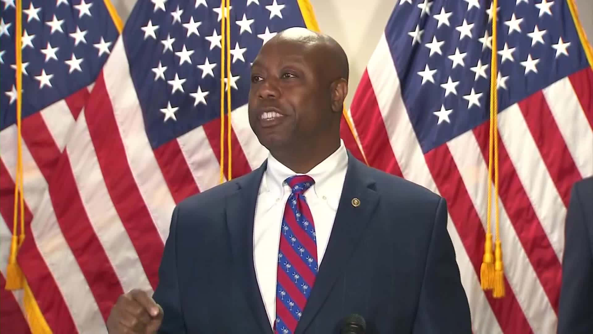Tim Scott With Three American Flags Background