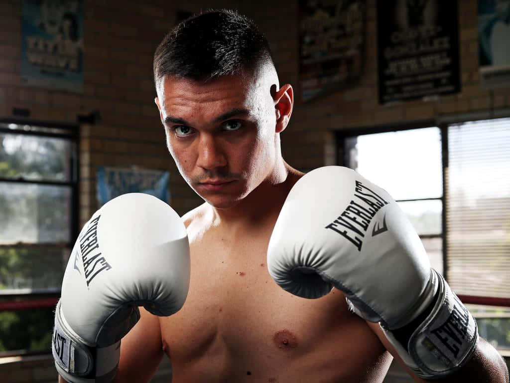 Tim Tszyu celebrating a victorious match in the boxing ring Wallpaper