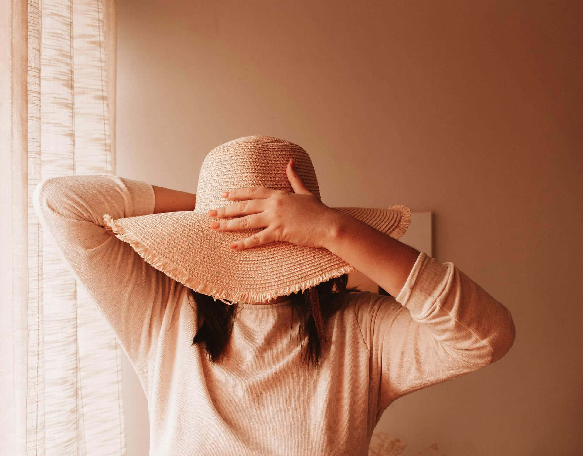 Timid Person Hiding Facewith Hat Wallpaper
