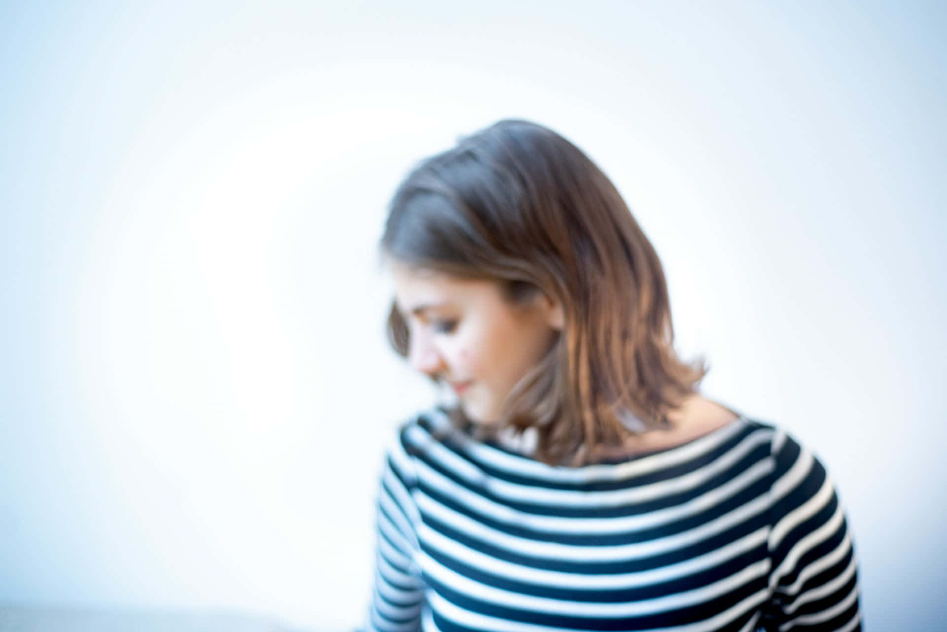 Timid Woman Looking Down Wallpaper