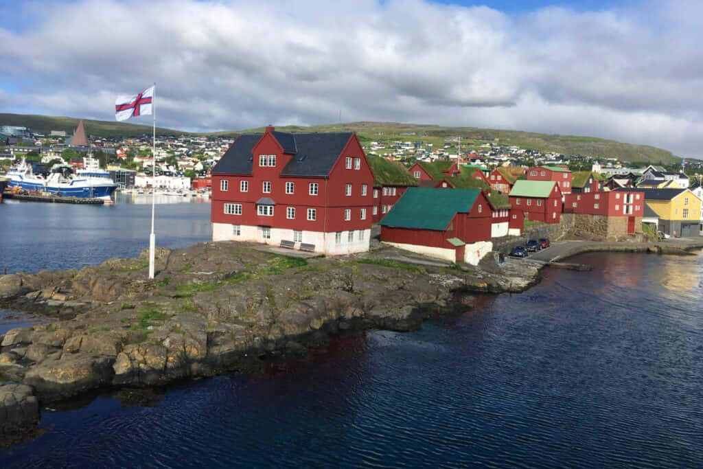 Tinganes With Faroe Island Flag At Thorshavn Wallpaper