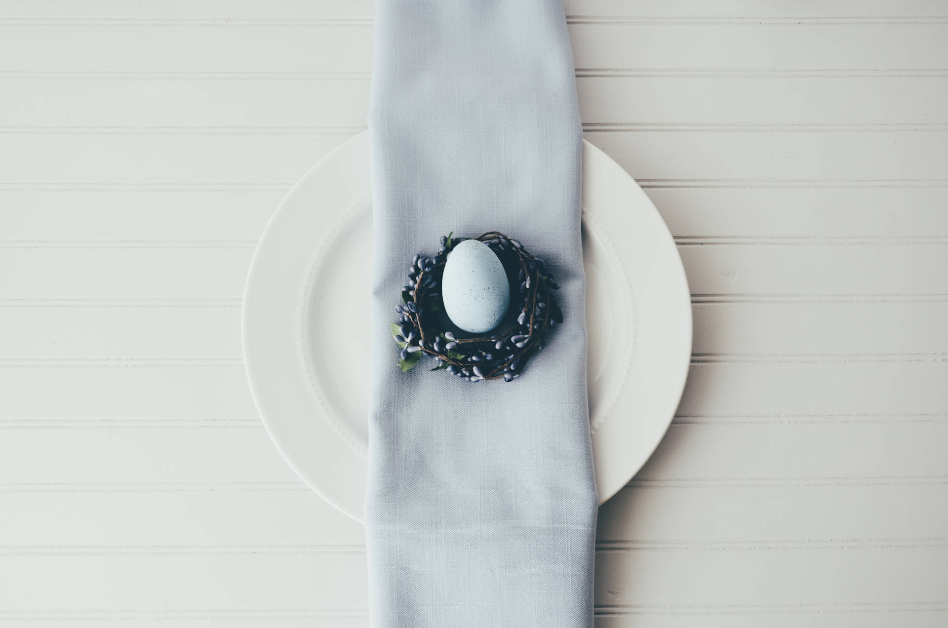 Tiny White Easter Egg On Plate Background