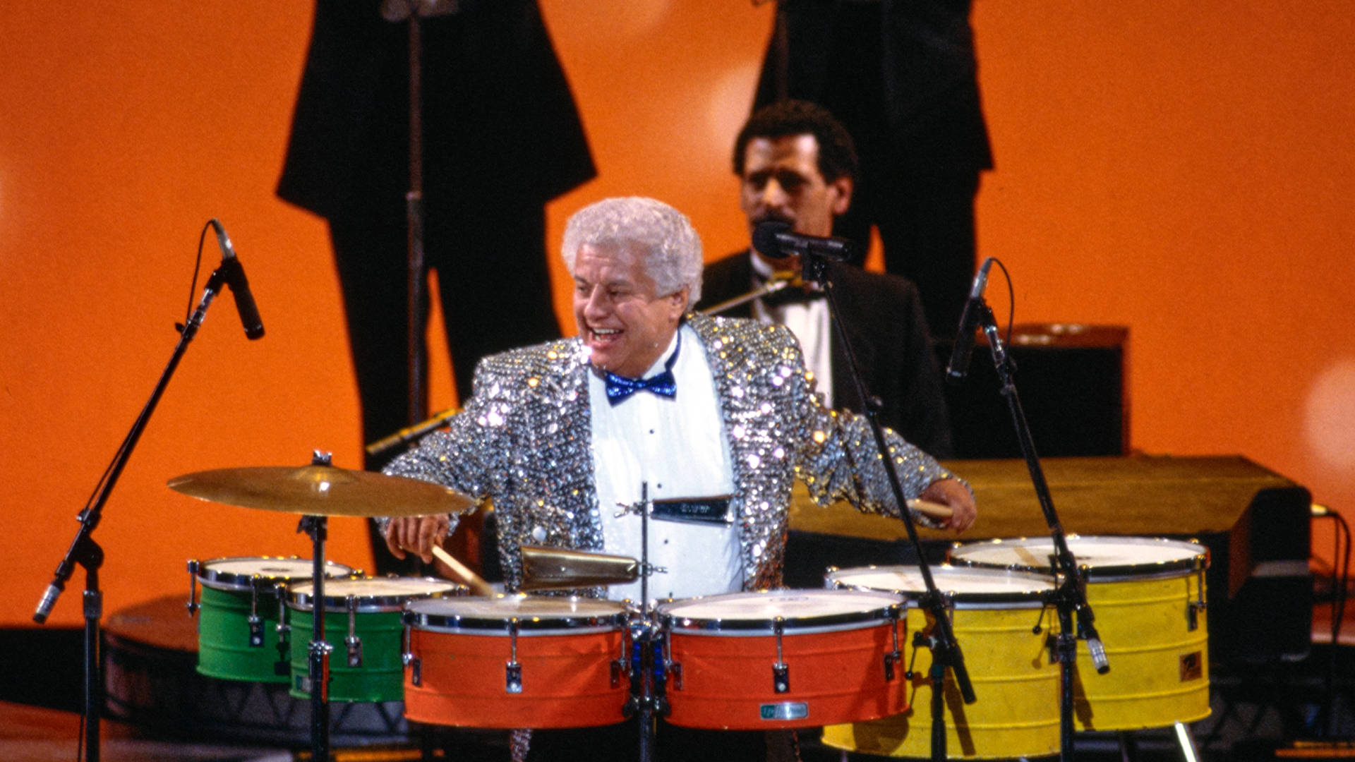 Tito Puente Playing Colorful Drums Wallpaper