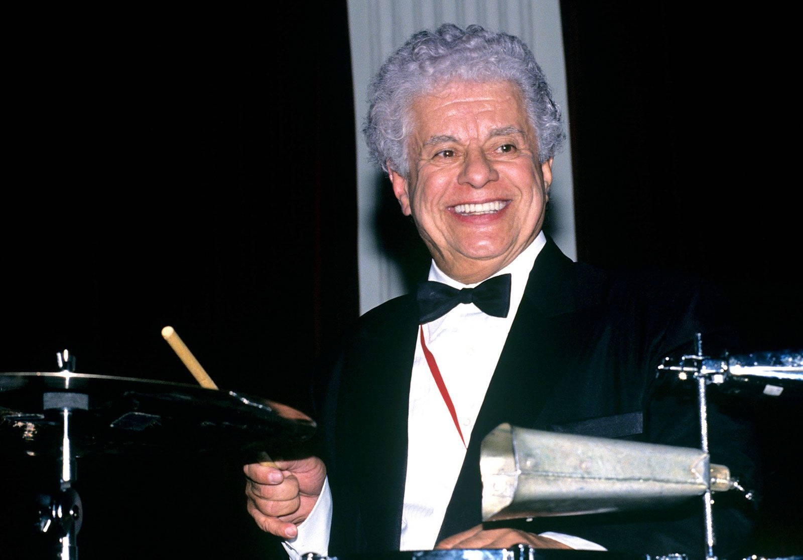 Tito Puente Smiling While Drumming Wallpaper