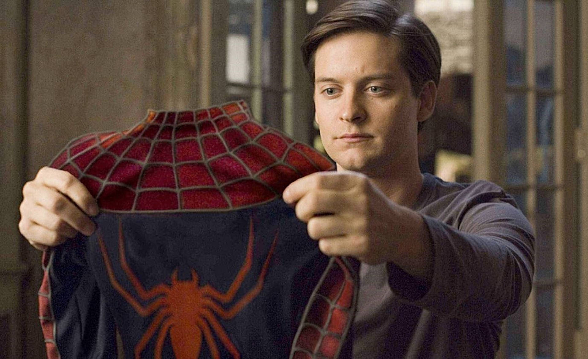 Tobey Maguire Holding Spider Man Suit Wallpaper